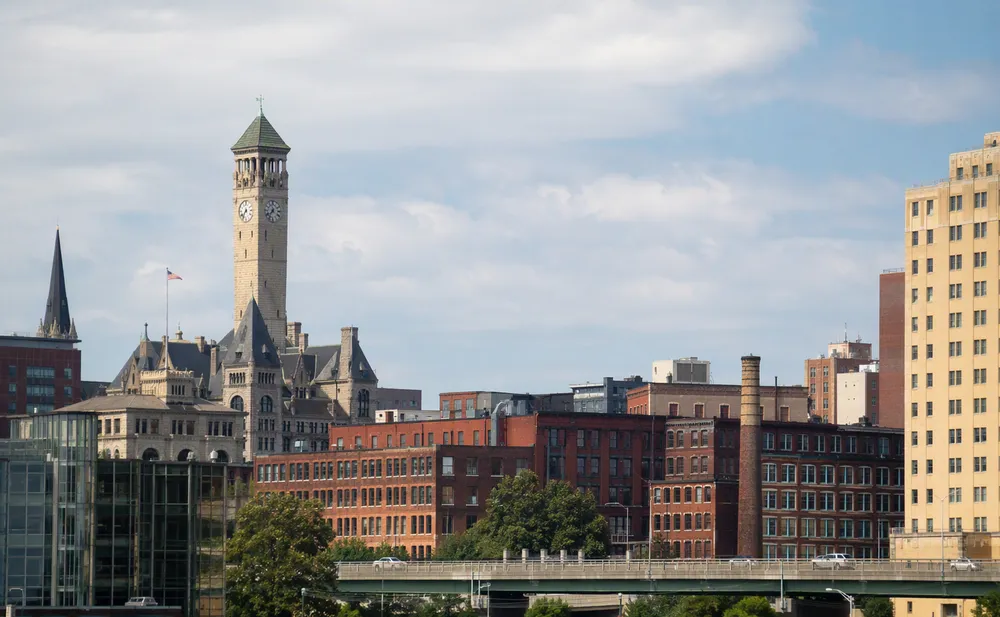 Downtown Waterbury skyline at dusk with the Santa Fe Building rising over the Naugatuck Valley